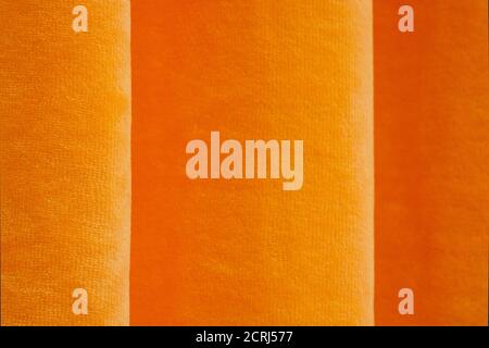 Abstrakter Hintergrund von orange gelb. Abstrakte Textur aus Stoff oder Textil von orange-gelber Farbe. Stockfoto