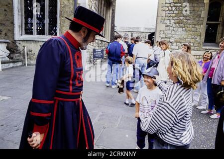 Yeoman Warder am Tower of London im Dienst mit Schulkindern und Touristen. 10. August 1993. Foto: Neil Turner Stockfoto