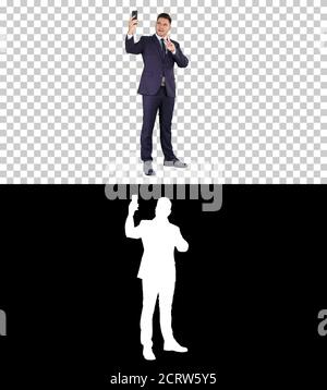 Glücklich junge gut aussehende Geschäftsmann Aufnahme vlog mit seinem Telefon, Stockfoto