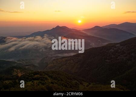 Landschaft aus den Rhodopen in Bulgarien bei Sonnenuntergang oder Sonnenaufgang. Kleine Kapelle und Kloster in der Nähe von Borovo, Rhodopen. Stockfoto