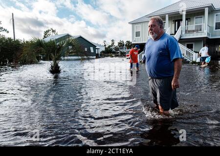 Orange Beach, ALABAMA, USA. September 2019. Chuck Anderson geht durch ein vom Hurrikan Sally überflutetes Viertel, nachdem er am 16. September 2020 in Orange Beach, Alabama, USA, Eissäcke verteilt hatte. Hurrikan Sally landtete am Morgen als Kategorie-2-Hurrikan. Quelle: Dan Anderson/ZUMA Wire/Alamy Live News Stockfoto