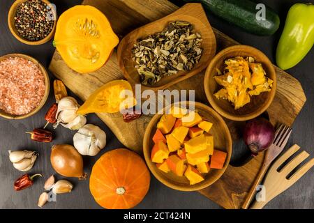 Geschnittener hokkaido-Kürbis auf einem Holzbrett. Hausgemachte Zubereitung von Kürbissuppe. Frisches Gemüse. Gesunde Ernährung. Stockfoto