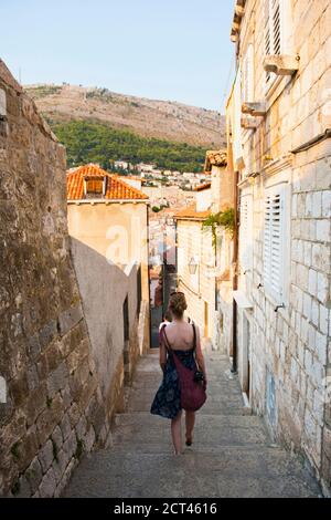 Dubrovnik Altstadt Foto, ein Tourist zu Fuß entlang einer engen Seitenstraße, Kroatien Stockfoto