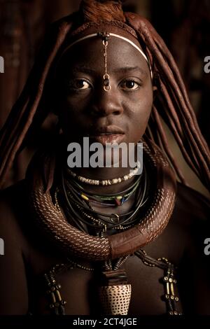Eine junge Himba-Frau posiert für ein Porträt in Epupa Falls, Kunene Region, Namibia. Stockfoto