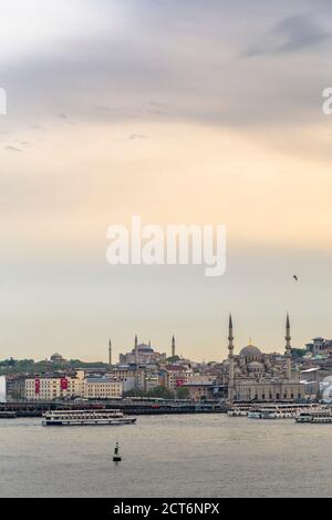 Neue Moschee (Yeni Cami) bei Sonnenuntergang mit Hagia Sophia (Aya Sofya) hinter dem Goldenen Horn, Istanbul, Türkei, Osteuropa, Hintergrund mit Kopierraum Stockfoto