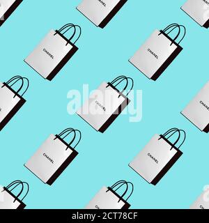 Nahtloses Muster aus weißen Einkaufstaschen mit dem CHANEL-Logo auf blauem Hintergrund. Konzept des Einkaufs, Geschenke, Käufer, Rabatte. Draufsicht, Hintergrund, Stockfoto