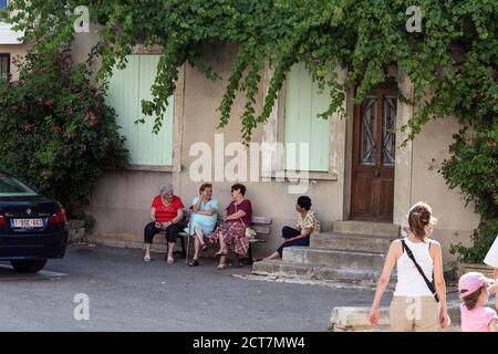 Ältere Frau sitzt auf der Bank. Sault, Frankreich - Juli 25 2018. Stockfoto