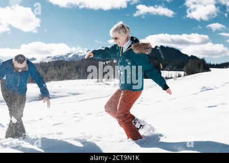 Deutschland, Bayern, Winklmoosalm, älteres Paar mit einer Schneeballschlacht Stockfoto