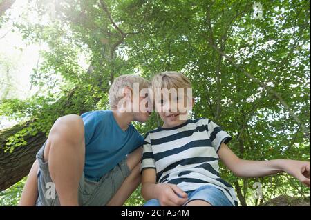 Deutschland, Bayern, jungen flüstern ins Ohr seines Freundes Stockfoto