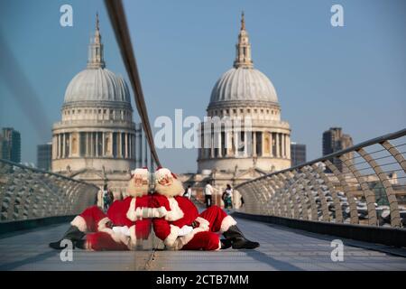 REDAKTIONELLE VERWENDUNG NUR EIN Mann, der als Weihnachtsmann verkleidet ist, bittet Passanten in London, ihn rechtzeitig zur Vorstellung des Weihnachtsfernsehens von Sony Movies aufzuwecken, der am 24. September live geht. Stockfoto