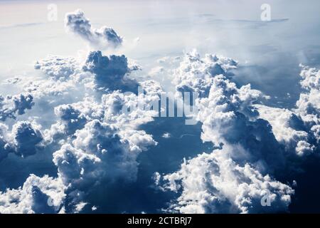 Cumulus Gewitterwolken in blauem Himmel am Morgen des Sonnenlichts. Schöne Sommerlandschaft mit wolkigen Skyline, Luftbild aus fliegenden Flugzeug Fenster Stockfoto