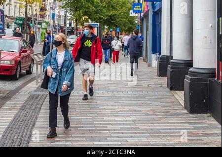 Cork, Irland. September 2020. Die Leute laufen entlang der Patrick Street in Cork City - einige mit Gesichtsmasken und andere ohne. COVID-19-Fälle nehmen landesweit zu, und es wird befürchtet, dass weitere Einschränkungen eingeführt werden. Quelle: AG News/Alamy Live News Stockfoto