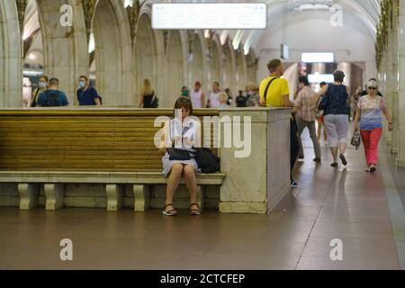 Moskau, Russland - 6. Juli 2020: U-Bahn-Station Paweletskaya (Zamoskvoretskaya Linie) im Sommer. Einige Menschen tragen Schutzmasken. Frau, die bei t sitzt Stockfoto