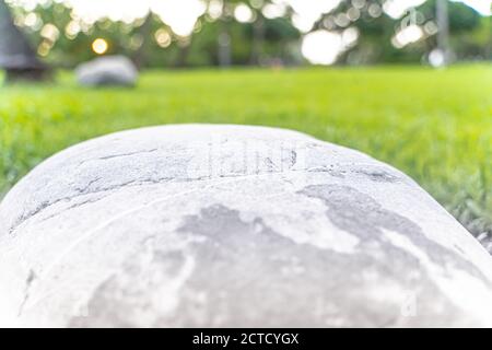 Morgens liegt ein großer Stein auf einer grünen Wiese. Wie ein Kunstfertigkeit aus einem Künstler. Stockfoto