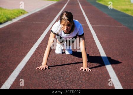 Ein Teenager-Mädchen tut Push-ups auf dem Spielplatz. Fitness, Sport, Gesundheit. Stockfoto