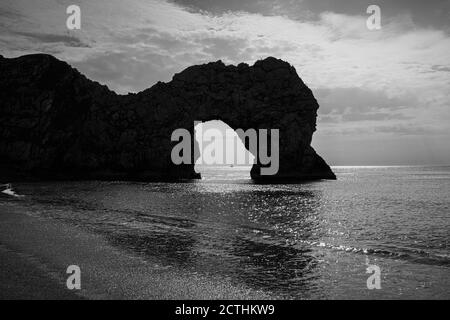 Am späten Nachmittag wurde die malerische Felsformation Durdle Door auf der Jurassic Coast World Heritage Site in Dorset, Südwestengland, mit einem Silhouettenbild betrachtet Stockfoto