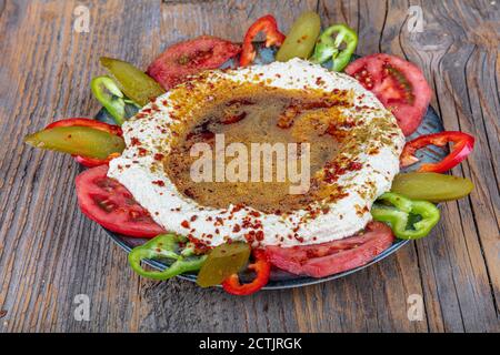 Klassischer Hummus mit Petersilie auf dem Teller und Pita-Brot. Hummus Chickpea. Schüssel mit arabischem oder libanesischem vegetarischem Hummus. Stockfoto