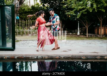 Männer und Frauen tanzen am Pool Stockfoto