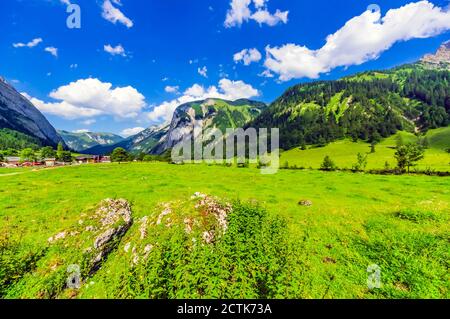 Österreich, Tirol, Vomp, landschaftlich reizvoller Blick auf das grüne Unterinntal im Sommer mit Dorf im Hintergrund Stockfoto