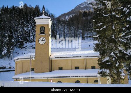 Campodolcino, Provinz Sondrio, Lombardei, Italien. St. Johannes der Täufer Kirche. Bereits in der '400, wurde Erweiterung, Restaurierung und Modifikationen an der aktuellen Struktur mit 3 Schiffen. Im Inneren befinden sich einige wertvolle Werke, wie zwei geschnitzte Holzaltäre aus dem 18. Jahrhundert, der Hochaltar und der Altar des Kruzifix. Hier wurde der kleine Luigi Guanella am 20. Dezember 1842 getauft. Wurde Heiliger im Jahr 2011. Stockfoto