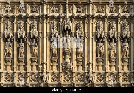 London, Großbritannien. Statuen über dem Eingang des Sovereign zu den Houses of Parliament unter dem Victoria Tower. Königin Victoria in der Mitte, flankiert von... Stockfoto