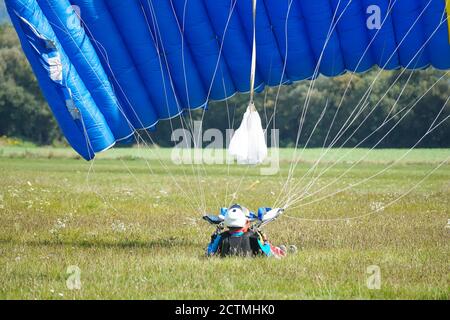 Tandem Fallschirm springen kurz nach dem Moment der Landung bunte Aufnahme in Slavnica, Slowakei am 19. September 2020. Emotionen, Glück, Mut. Stockfoto