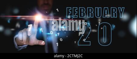 februar. Tag 20 des Monats, Werbung oder High-Tech-Kalender, Mann in Anzug drückt helle virtuelle Taste Wintermonat, Tag des Jahres Konzept. Stockfoto