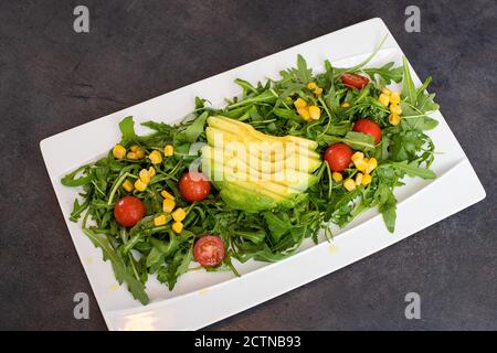 Blick von oben auf Avocadosalat auf weißem Teller Stockfoto