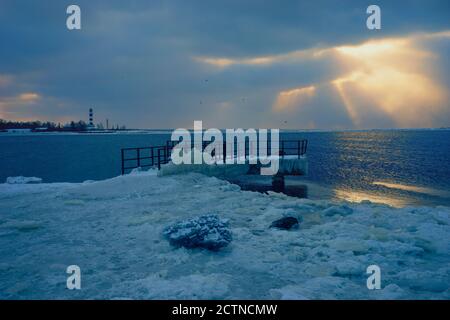 Pier im Winter im Eis im Fluss gefroren Stockfoto