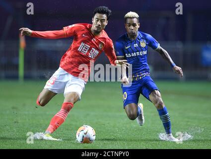 (200924) -- DALIAN, 24. September 2020 (Xinhua) -- Alex Teixeira (R) von Jiangsu Suning steht mit Park Ji-Soo von Guangzhou Evergrande Taobao während des 13. Spielrunde zwischen Jiangsu Suning und Guangzhou Evergrande Taobao bei der verschobenen Saison 2020 Chinese Football Association Super League (CSL) Dalian Division in Dalian, Nordost Chinas Provinz Liaoning, 24. September 2020. Jiangsu Suning schlug Guangzhou Evergrande Taobao mit 2:1. (Xinhua/Langer Lei) Stockfoto