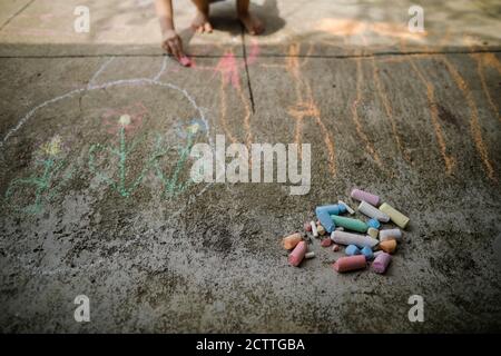 Bild mit geringer Schärfentiefe (selektiver Fokus) mit farbiger Kreide für Kinder auf einem Betonpflaster. Stockfoto