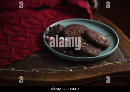 Schokoladenkekse mit gefrorenen Kirschen auf dem Teller. Dark and Moody, Mystic Light Food Fotografie. Stockfoto