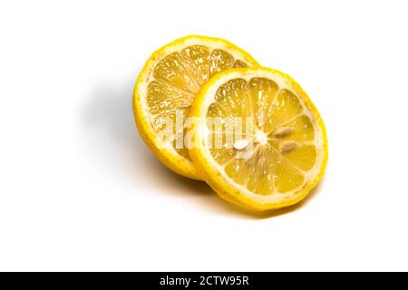 Frische Zitrone mit der Hälfte und Blätter isoliert auf weiß Stockfoto