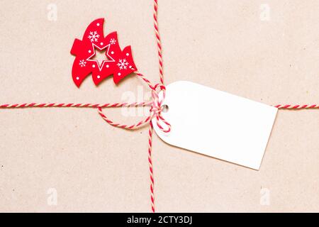 Geschenkanhänger und Spielzeug Weihnachtsbaum auf braunem Papier. Weihnachten und Neujahr Hintergrund mit Kopierplatz. Stockfoto