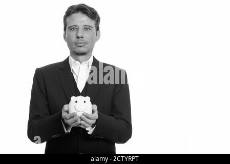 Portrait von gutaussehenden Geschäftsmann in Anzug halten Sparschwein Stockfoto