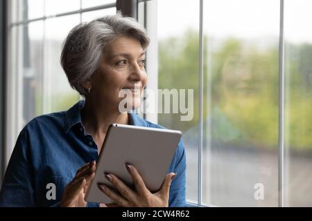 Happy moderne reife Frau mit Tablet-Gadget Stockfoto