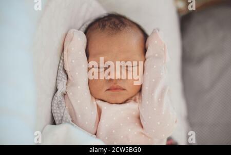 Nahaufnahme eines Neugeborenen, das in Weiß schläft Kleidung zu Hause Stockfoto