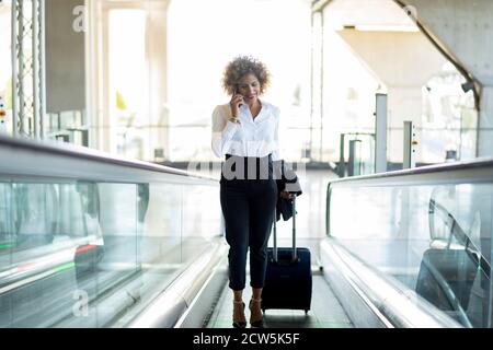 Stewardess mit ihrem Koffer am Flughafen Stockfoto