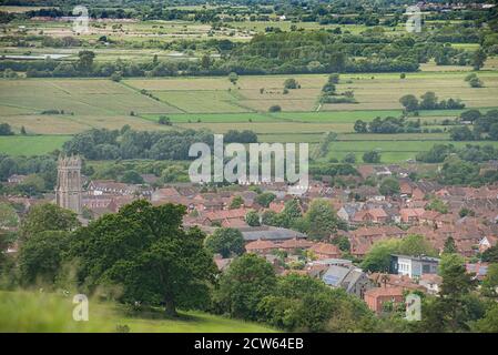 Glastonbury Stadt von einem lokalen Hügel aus gesehen. Rote Dächer in der Gemeinde mit umliegender abgesicherter Ackerfläche. Wallfahrtsort für New Agers. Stockfoto
