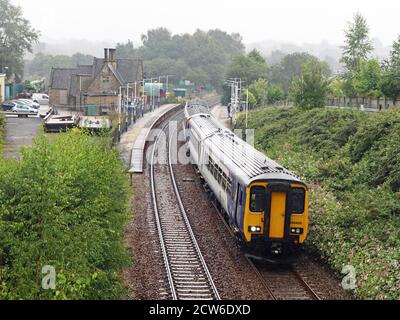 Ein Northern Zug verlässt Appley Bridge Station an einem nassen Morgen im Großraum Manchester, der Bahnhof ist auf der Linie von Wigan Wallgate nach Southport. Stockfoto