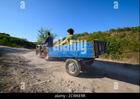 Minitraktor mit Fahrgästen auf der unbefestigten Bergstraße im Norden Moldawien Stockfoto