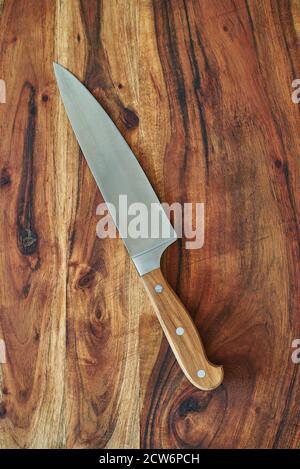 Holzschneidebrett mit frischem Gemüse und einem Kochmesser. Gemüse auf einem Holzschneidebrett hacken. Stockfoto