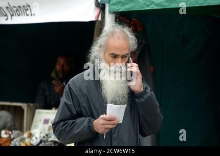 Graubärtiger alter Gent, auf Handy. Stockfoto