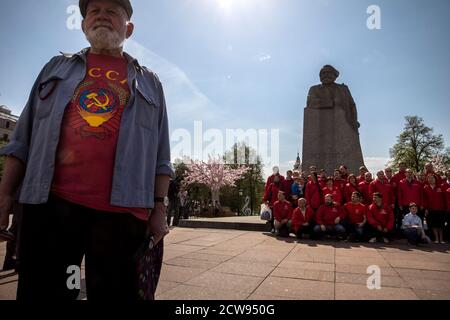 Moskau, Russland. 5. Mai 2018 Menschen halten ein Porträt von Karl Marx und legen Blumen an der Gedenkstatue von Karl Marx während der Feierlichkeiten zum 200. Jahrestag seiner Geburt, in Moskau, Russland Stockfoto