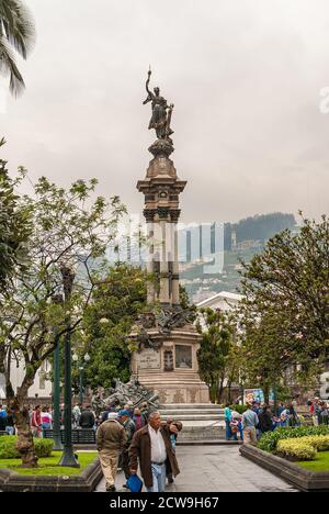 Quito, Ecuador - 2. Dezember 2008: Historische Innenstadt, Plaza Grande. Unabhängigkeitsdenkmal, oder Helden des August 10, unter grünem Laub unter grauem Bro Stockfoto