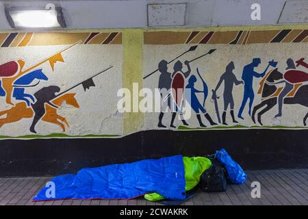 England, East Sussex, Hastings, Rough Sleeper in Front of Mural, das die normannische Invasion von England 1066 darstellt Stockfoto