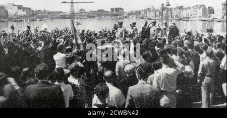 Schwarz-Weiß-Fotografie des Zweiten Weltkriegs (1939-1945) zeigt das Bild der Landung der Alliierten in der Provence im Jahr 1944; der französische General Jean de Lattre de Tassigny (1889-1952), Kommandant der ersten französischen Armee, wird von einer Menschenmenge im Alten Hafen von Marseille bejubelt. Stockfoto