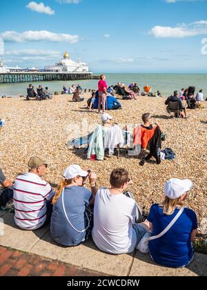 Eastbourne Strand und Pier, England. Eine englische Sommerlandschaft am Meer mit Touristen, die das saisonal warme Wetter an der britischen Südküste genießen. Stockfoto