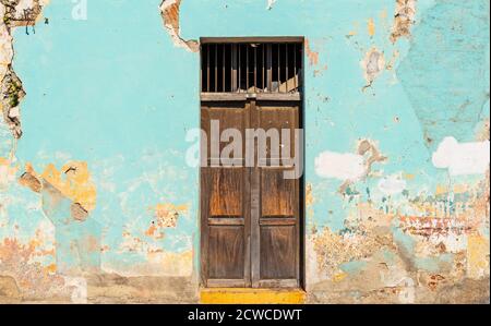 Im Kolonialstil vintage Holztür mit verwitterten Farbe an der Fassade, Antigua, Guatemala. Stockfoto