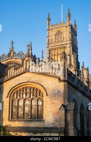 Die Kirche des heiligen Johannes des Täufers aus dem Garten der Erinnerung bei Sonnenaufgang im Herbst. Cirencester, Cotswolds, Gloucestershire, England Stockfoto